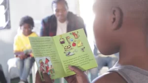 child reading a little zebra book.webp